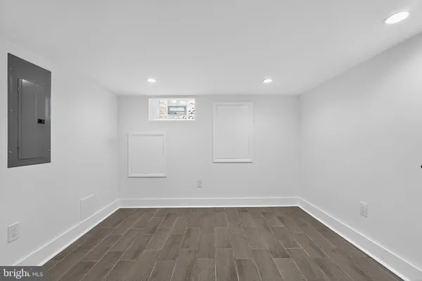 a view of a room with wooden floor and window
