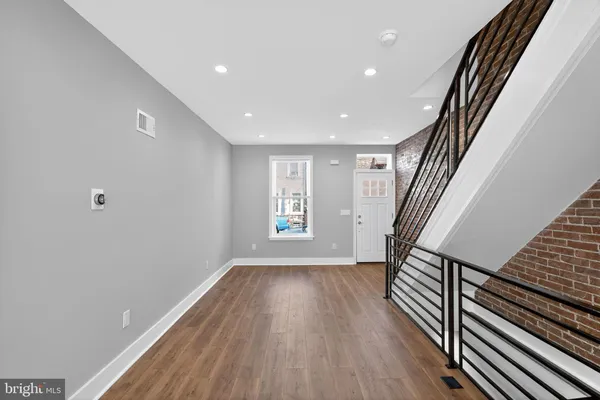 a view of entryway with wooden floor and stairs