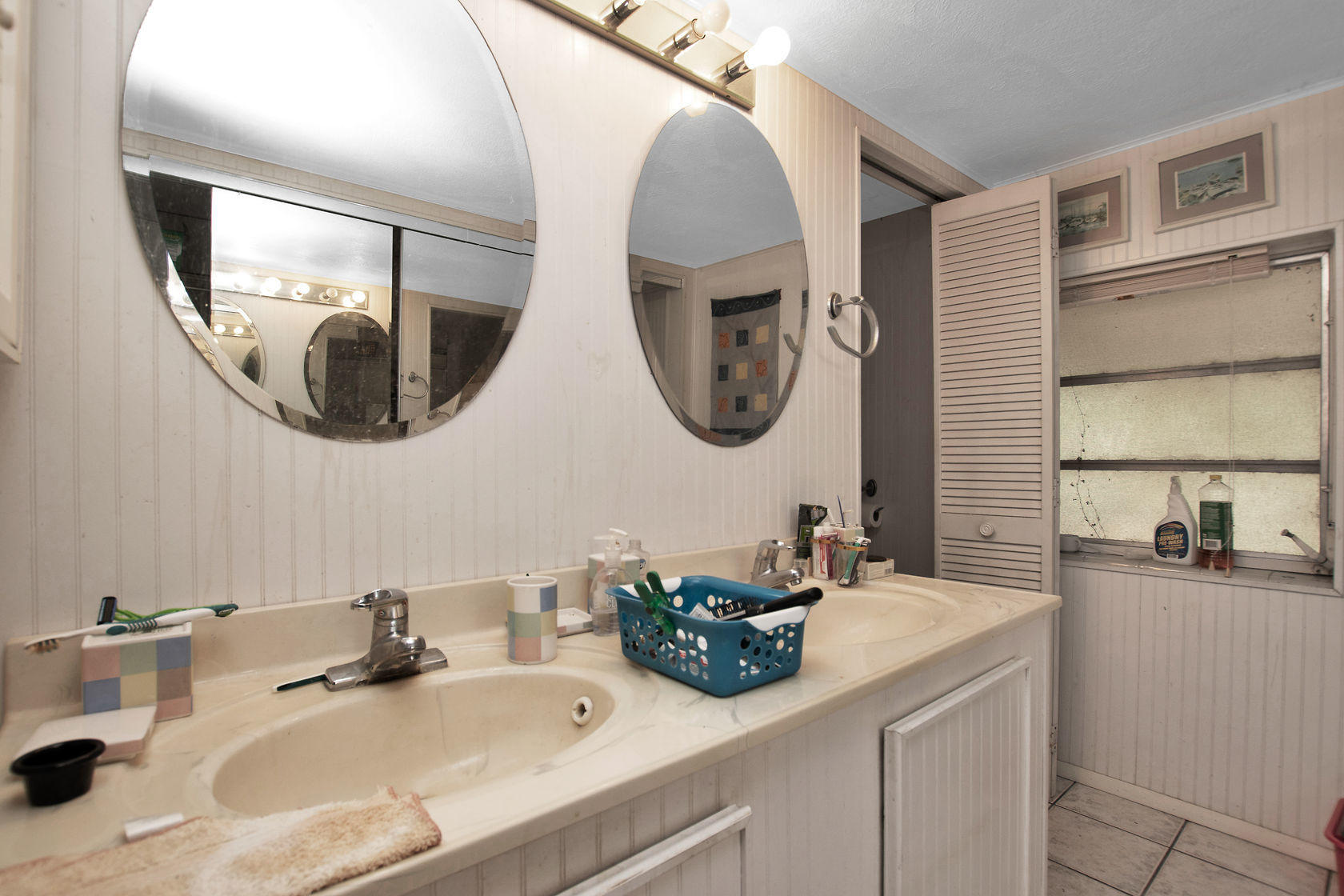 353 Sound Drive Key Largo, FL 33037 - Photo 23 of 28 a bathroom with a double vanity sink and a mirror