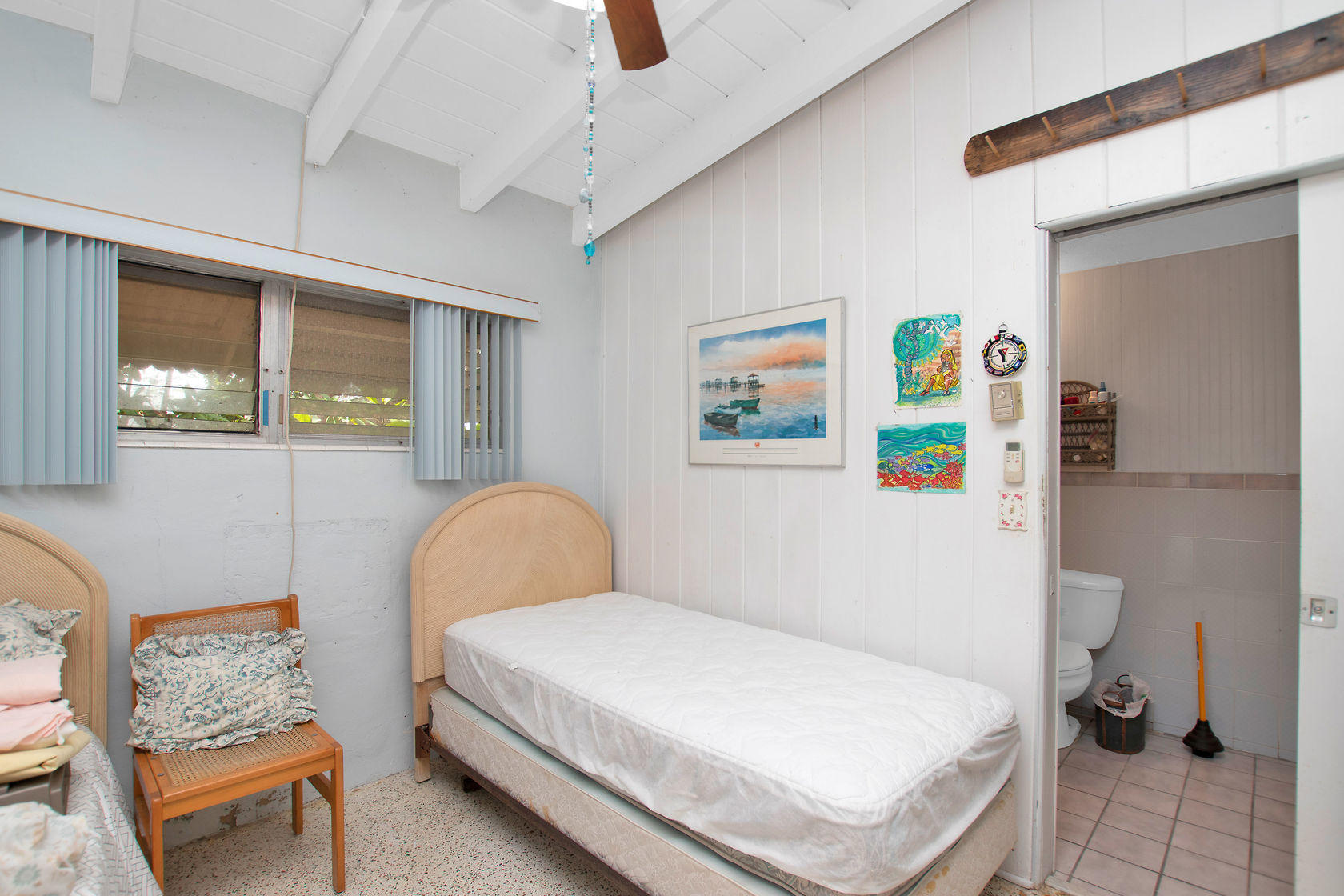 353 Sound Drive Key Largo, FL 33037 - Photo 6 of 28 a bedroom with a bed and a chair