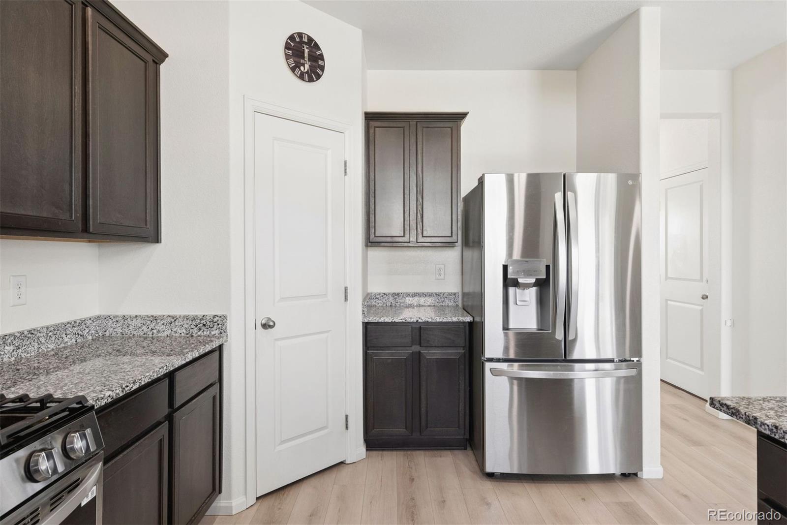 7307 Animas Avenue Frederick, CO 80530 - Photo 20 of 49 a kitchen with stainless steel appliances granite countertop a refrigerator and a stove