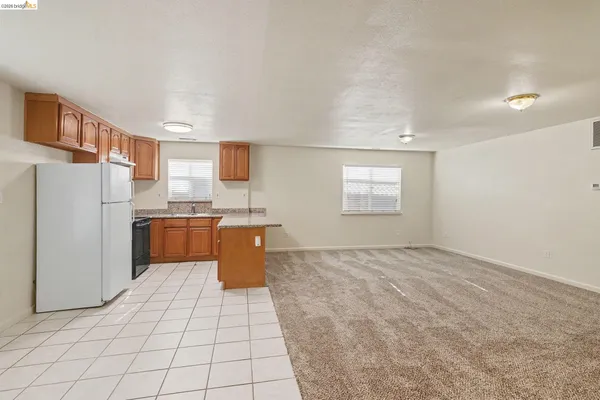 a kitchen with stainless steel appliances a refrigerator and a stove top oven
