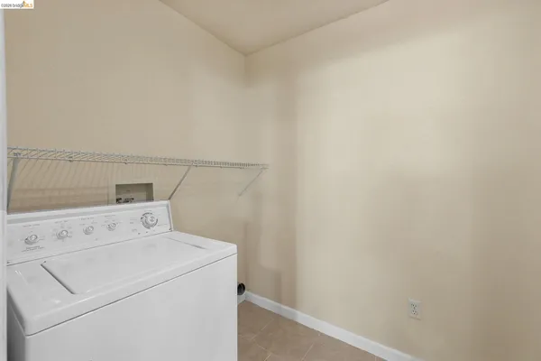 a view of washer and dryer with kitchen in the background