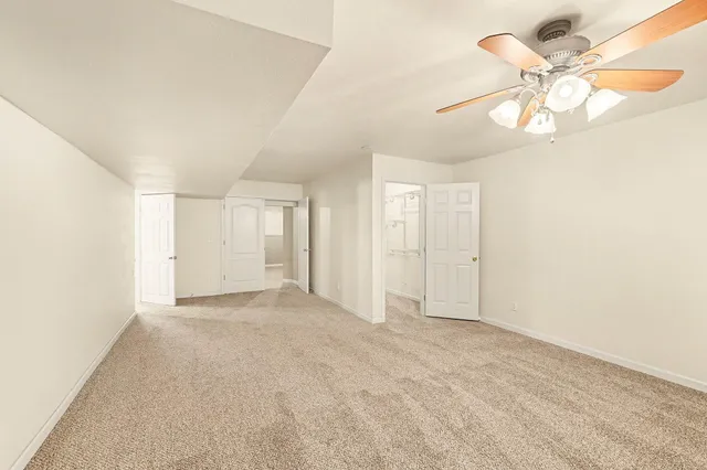 a view of a hallway to room with cabinet and cabinet