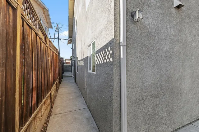 a view of a backyard with plants and a patio