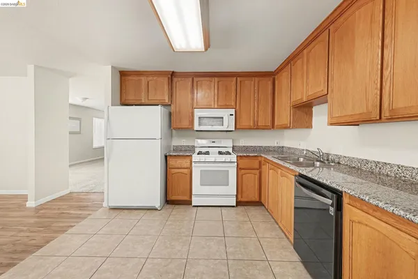 a kitchen with a white cabinets and white appliances