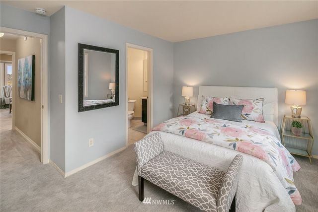 a bedroom with a bed and mirror