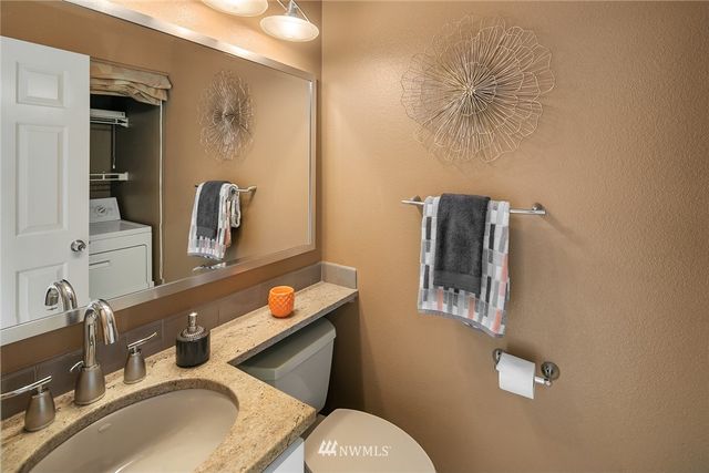 a bathroom with a sink mirror vanity and toilet