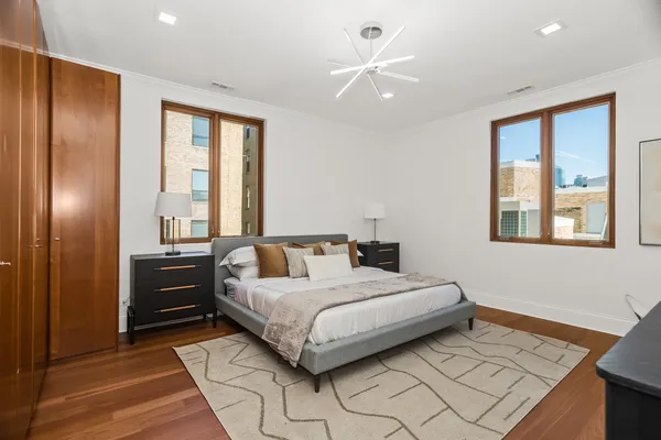 a bedroom with a bed and a chandelier