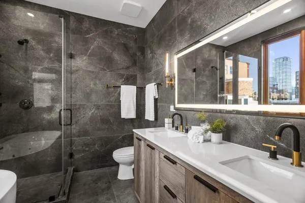 a bathroom with a sink toilet and shower