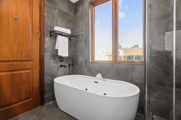 a white bath tub sitting next to a bathroom sink