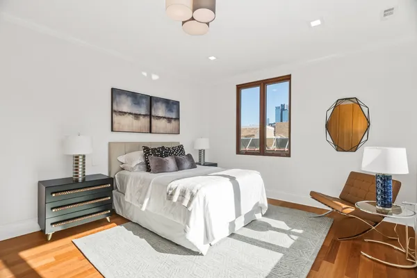 a bedroom with bed and a chandelier