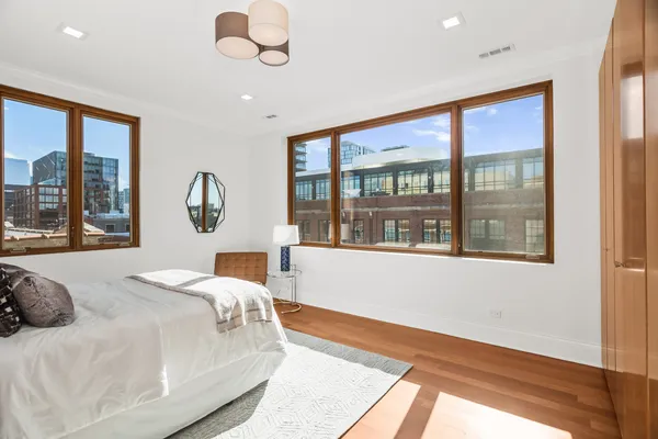 a bedroom with a large bed and a large window