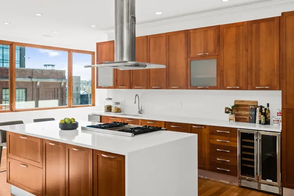 a kitchen with stainless steel appliances a stove a sink and a microwave