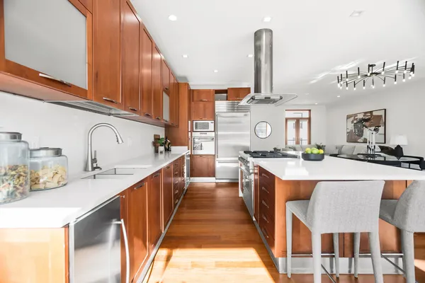 a kitchen with stainless steel appliances granite countertop a sink and a stove