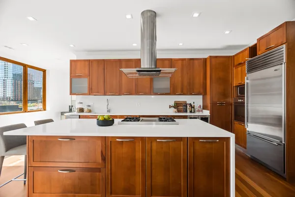 a kitchen with stainless steel appliances granite countertop a refrigerator a sink and a stove
