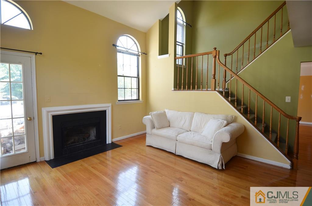 5206 Stonehedge Road Edison, NJ 08820 - Photo 3 of 13 a living room with furniture and a fireplace