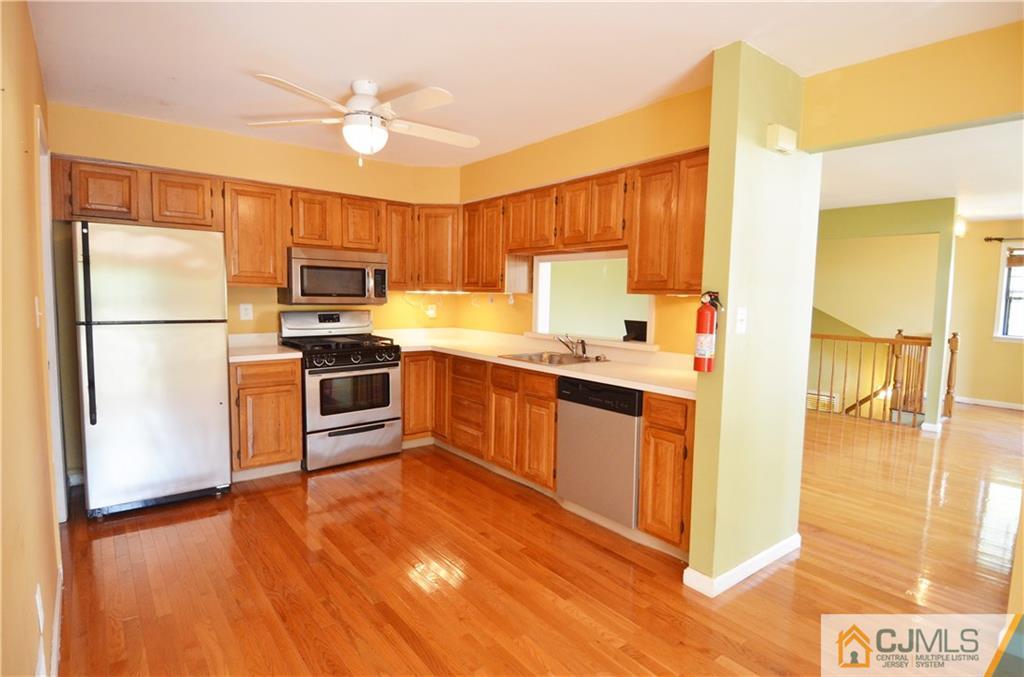 5206 Stonehedge Road Edison, NJ 08820 - Photo 6 of 13 a kitchen with a refrigerator a stove top oven and a sink