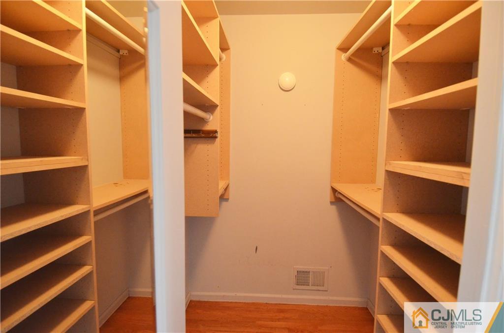 5206 Stonehedge Road Edison, NJ 08820 - Photo 9 of 13 a view of walk in closet with empty racks