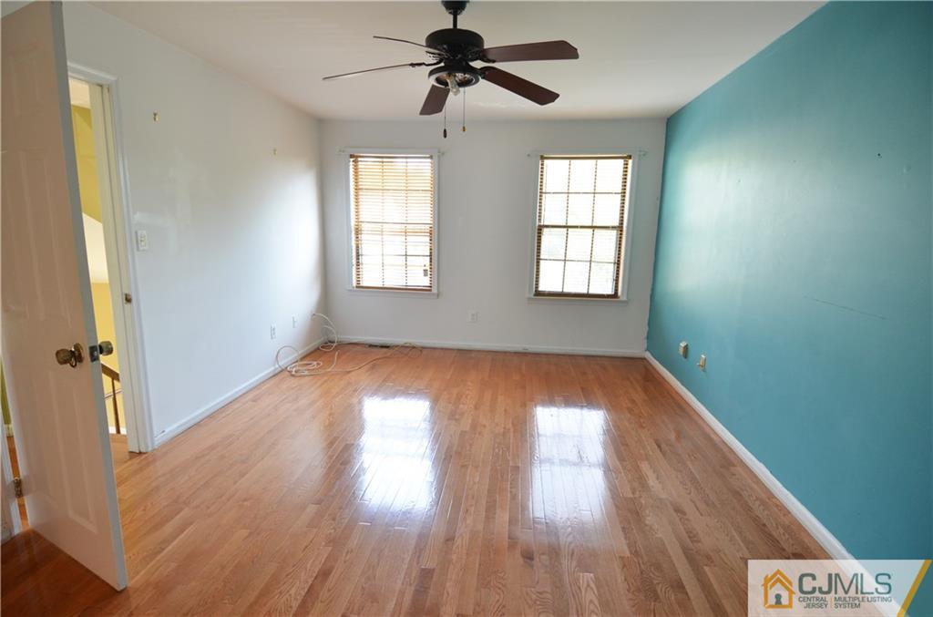 5206 Stonehedge Road Edison, NJ 08820 - Photo 10 of 13 wooden floor in an empty room with a window