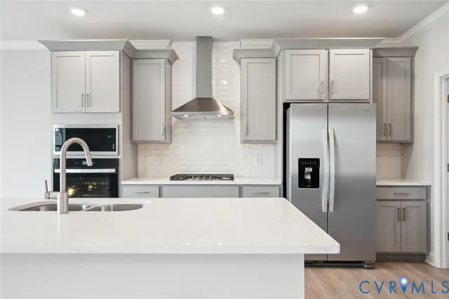 a kitchen with kitchen island a counter top space a sink and stainless steel appliances