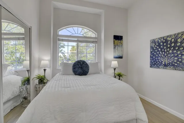 a bedroom with a bed and a chandelier