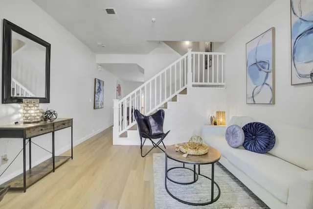 a view of entryway dining room and hall with wooden floor