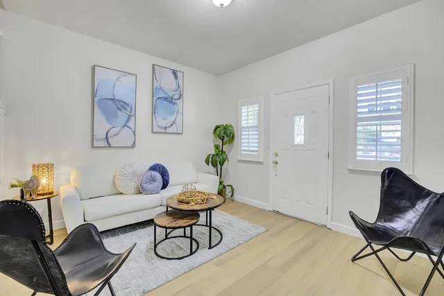 a living room with furniture and wooden floor