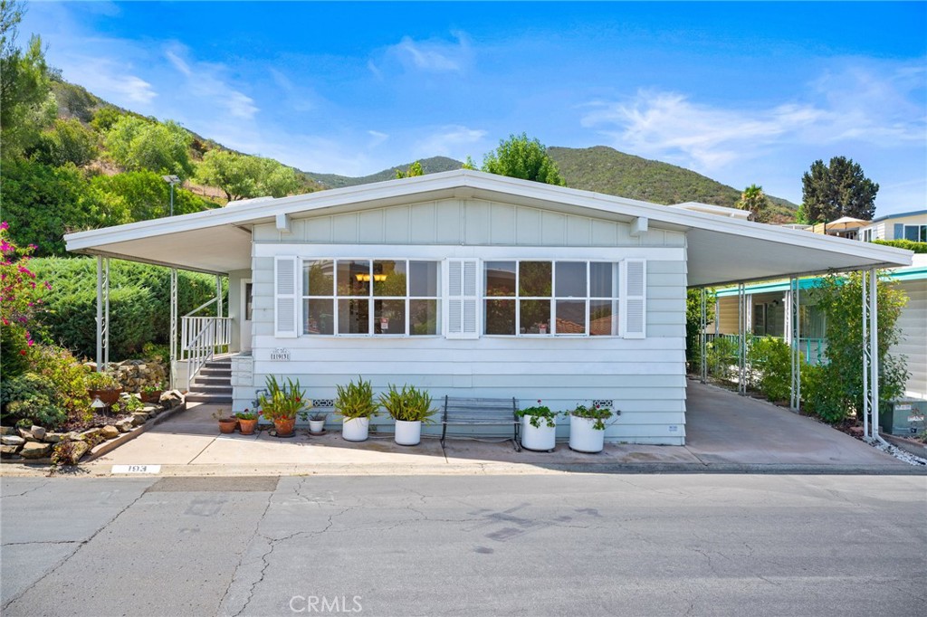 7467 Mission Gorge Road, Unit 193 Santee, CA 92071 - Photo 1 of 1 a front view of a house with a garden