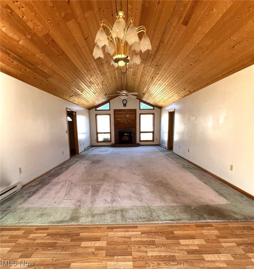 46292 Cedar Way Rogers, OH 44455 - Photo 3 of 12 Great room with lofted ceiling, ceiling fan with notable chandelier, a brick fireplace, light carpet, and wood ceiling