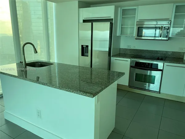 a view of a kitchen from a hallway