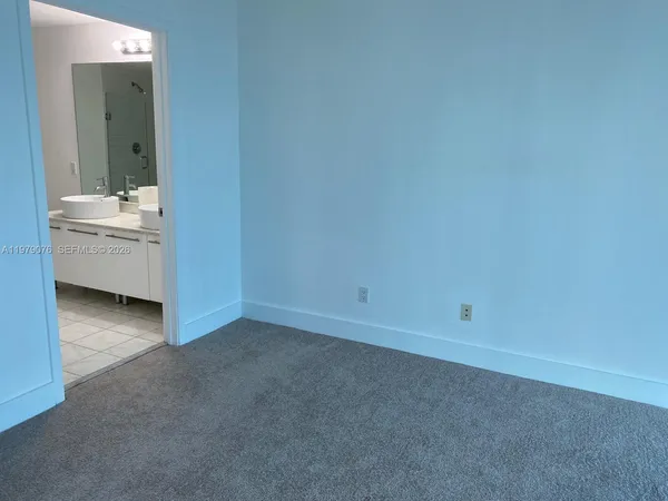 a view of room with a sink and mirror