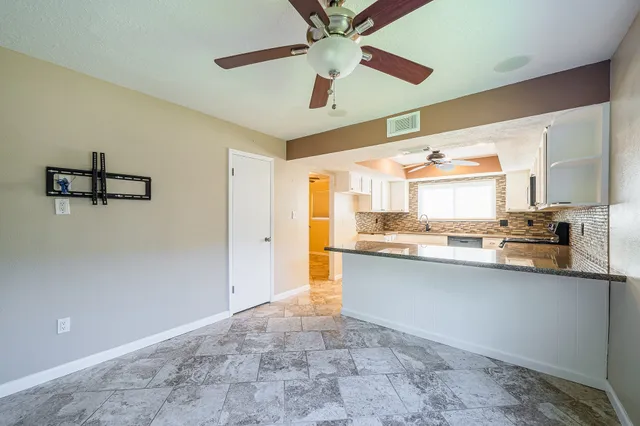 a kitchen with stainless steel appliances granite countertop a sink a stove a refrigerator a microwave oven with cabinets