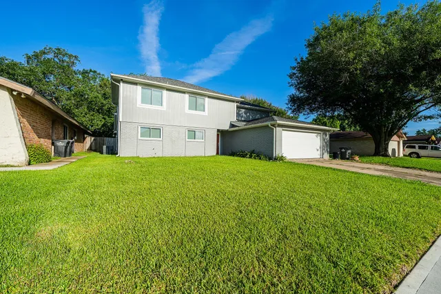 a front view of house with yard and green space