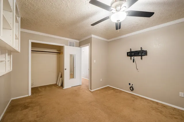 a view of a room with a ceiling fan