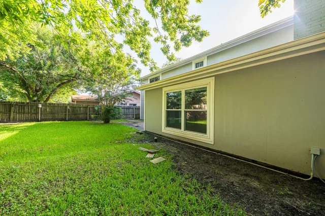 a view of a house with a backyard