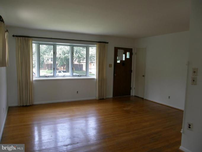 17 West Timonium Road Lutherville-Timonium, MD 21093 - Photo 2 of 17 Living room freshly painted with hardwood floors.