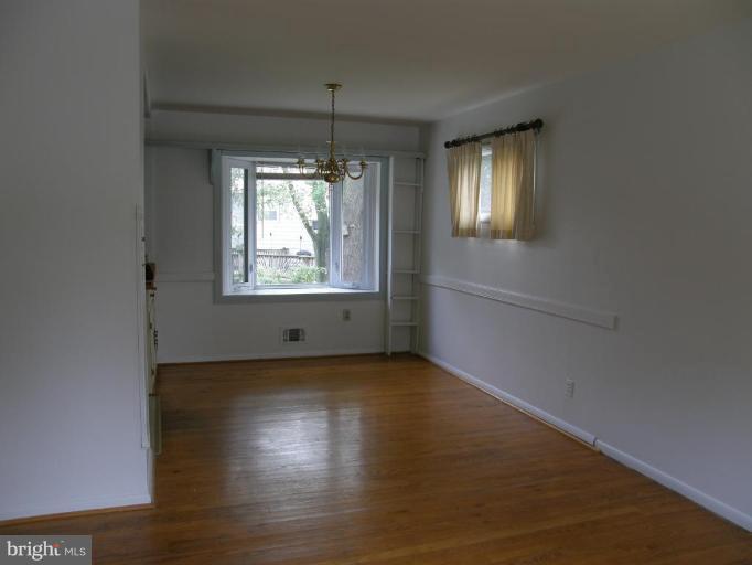 17 West Timonium Road Lutherville-Timonium, MD 21093 - Photo 3 of 17 Freshly painted dining room with hardwood floors.