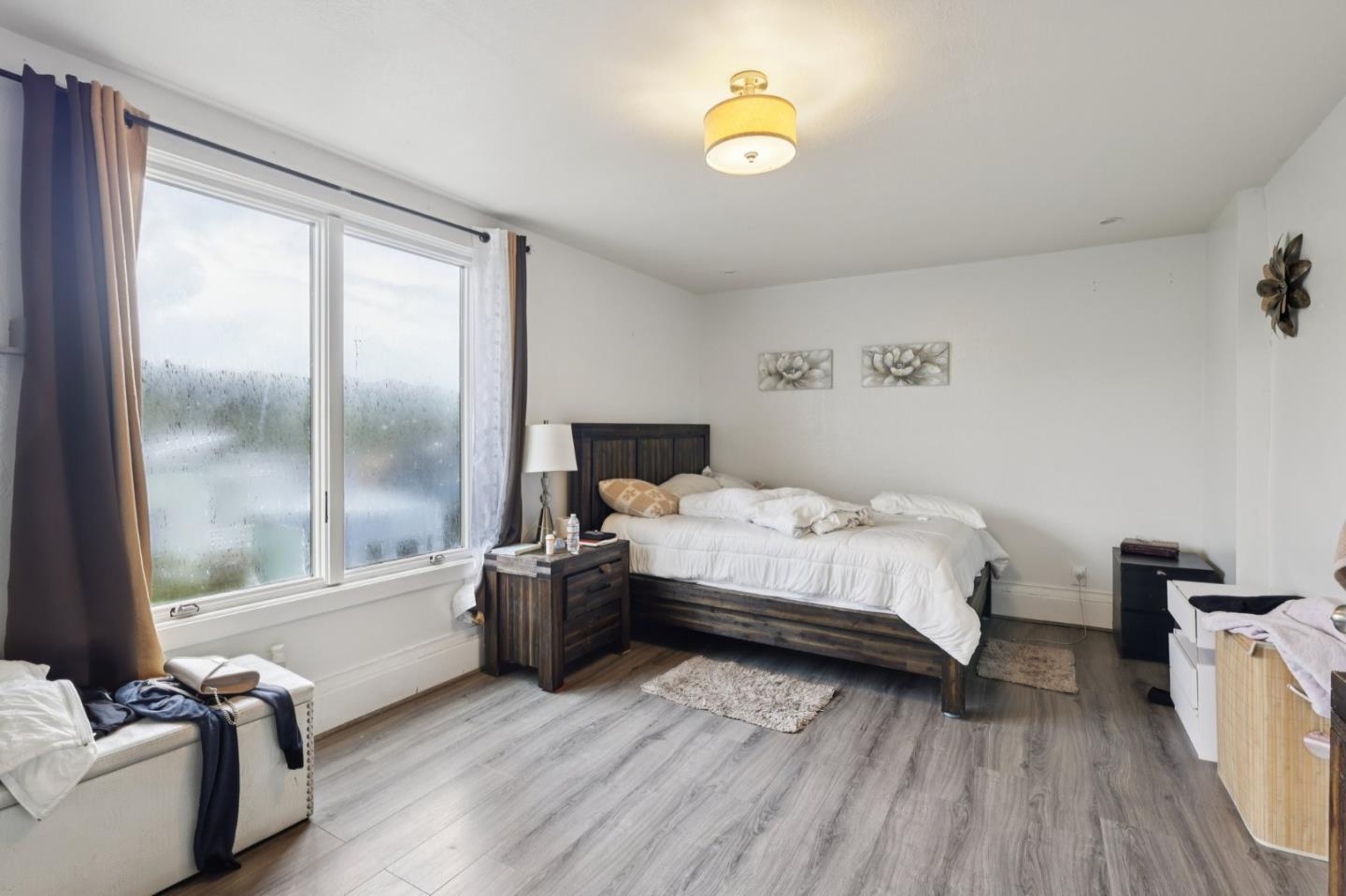 44 Patton Street San Francisco, CA 94110 - Photo 13 of 46 a bedroom with a bed and wooden floor