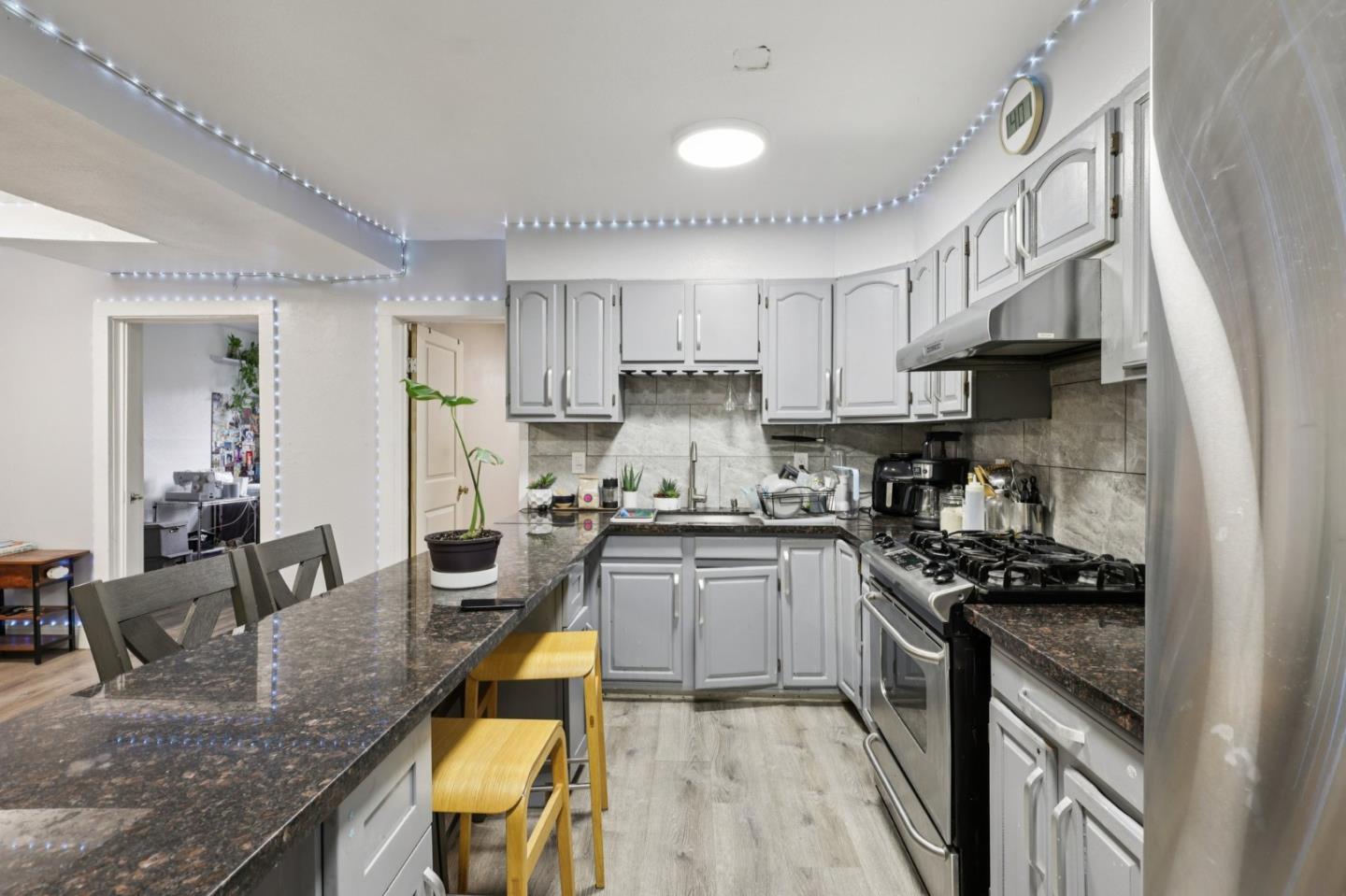 44 Patton Street San Francisco, CA 94110 - Photo 31 of 46 a kitchen with granite countertop a stove sink and cabinets