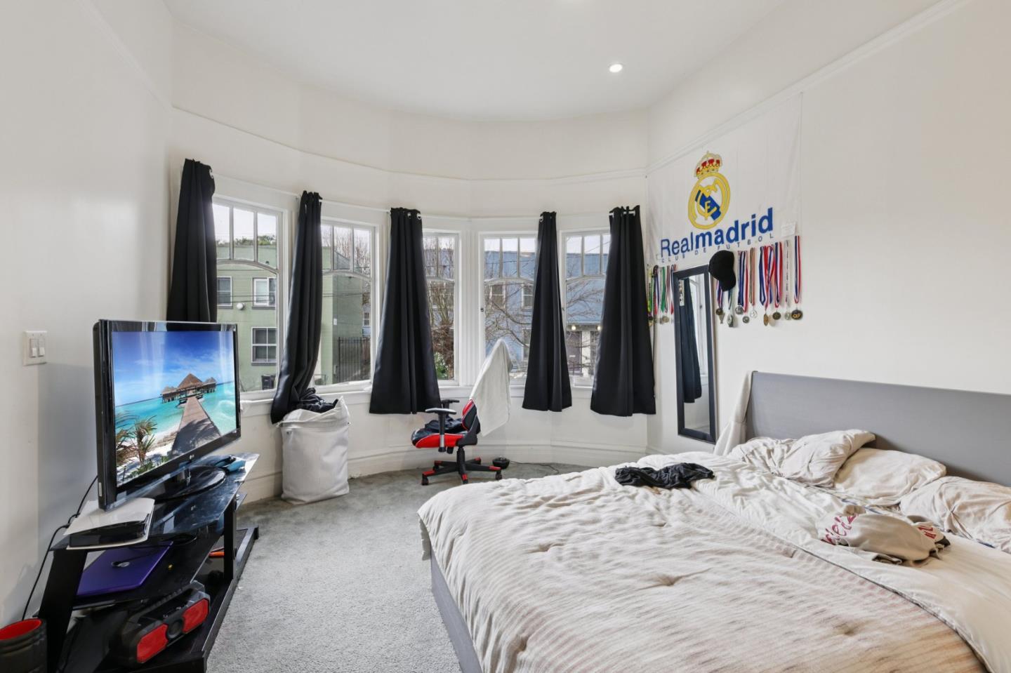 44 Patton Street San Francisco, CA 94110 - Photo 7 of 46 a bedroom with a bed and a flat tv screen on dresser