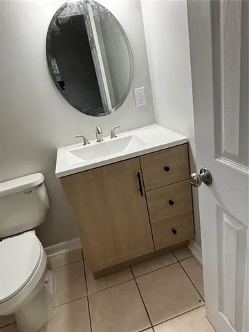 a bathroom with a sink toilet and mirror
