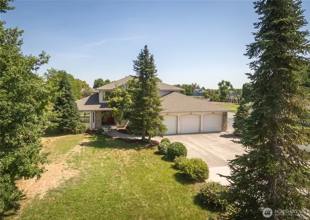 a view of a house with a yard and tree s