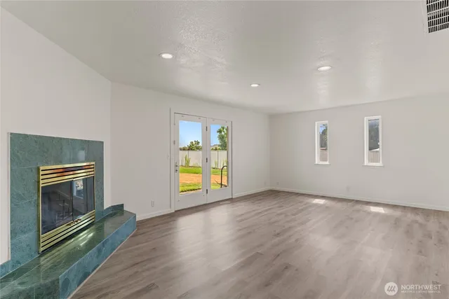 a view of empty room with a fireplace