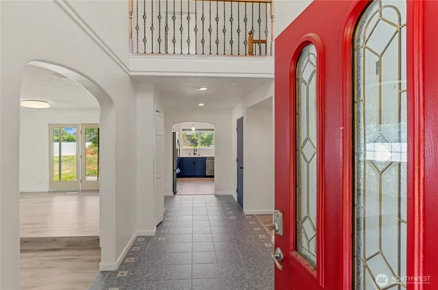 a view of a hallway with entryway front door