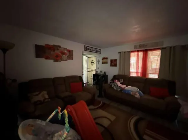 a living room with furniture and a window