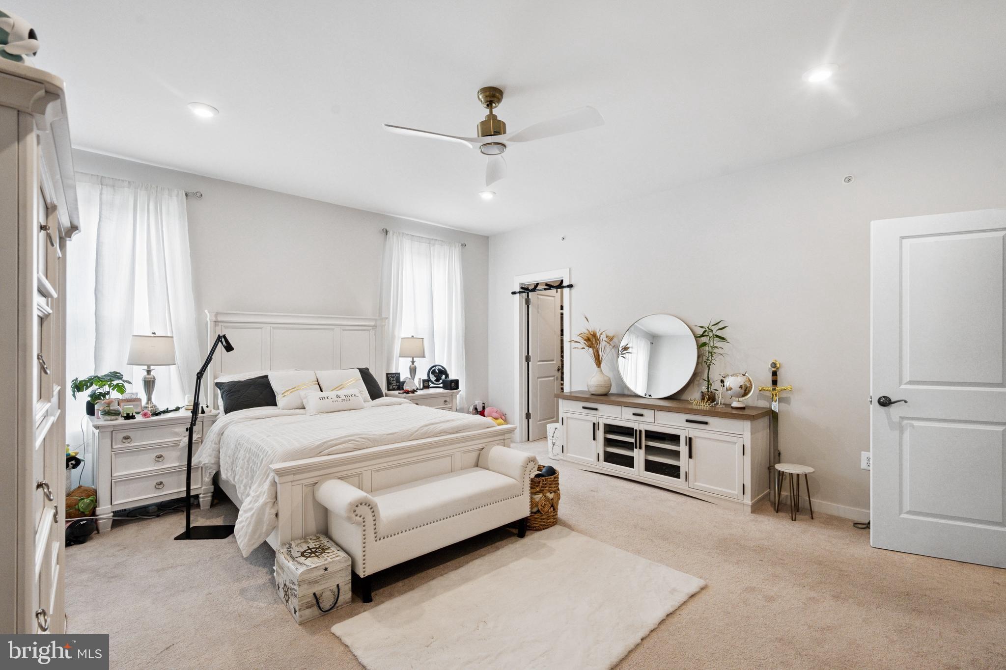 13506 Innovation Station Loop, Unit 2B Herndon, VA 20171 - Photo 18 of 32 a bedroom with a bed a chandelier and a window