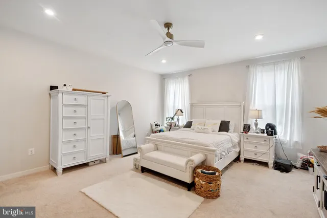 a spacious bedroom with a bed and a cabinets