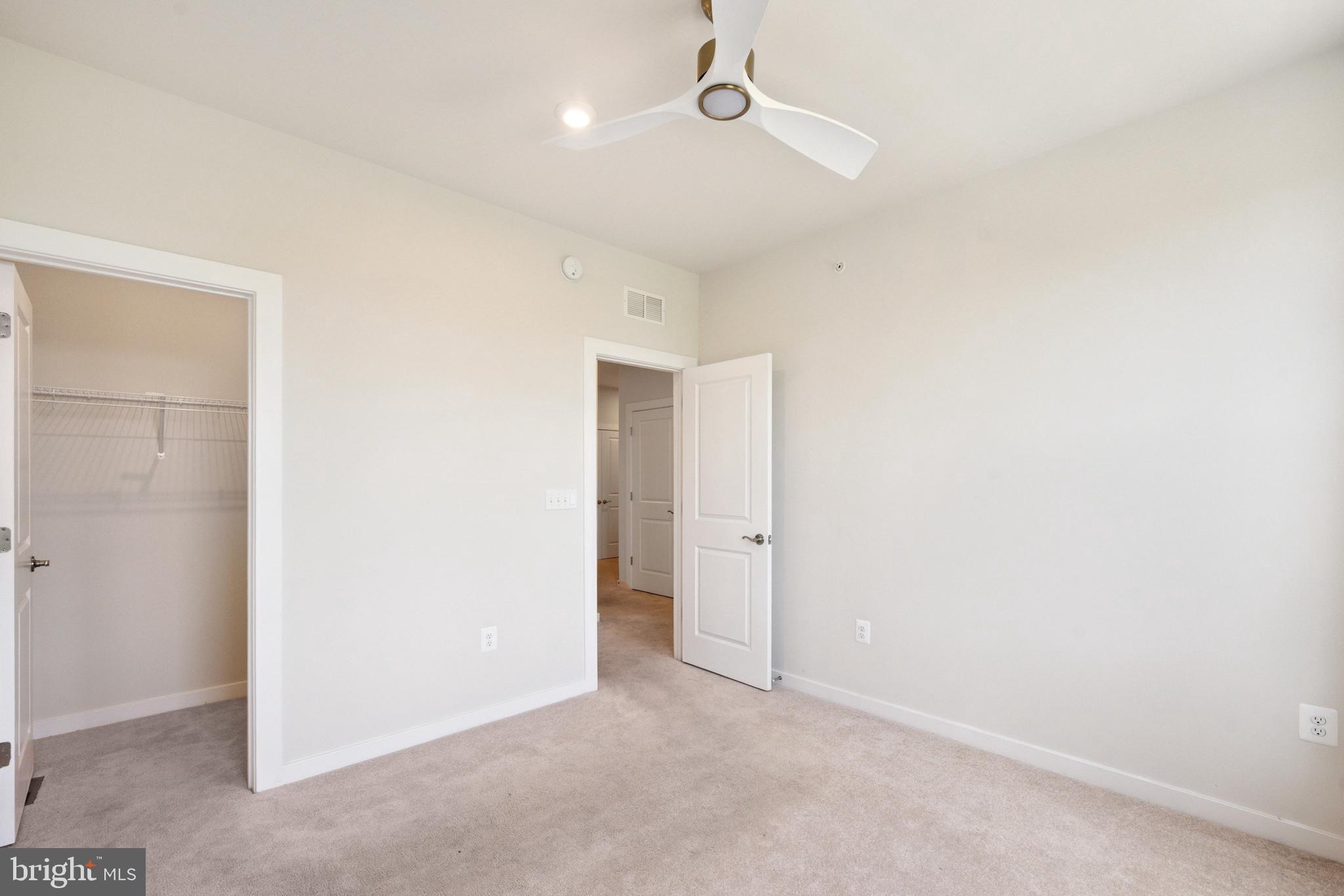 13506 Innovation Station Loop, Unit 2B Herndon, VA 20171 - Photo 21 of 32 an empty room with chandelier fan