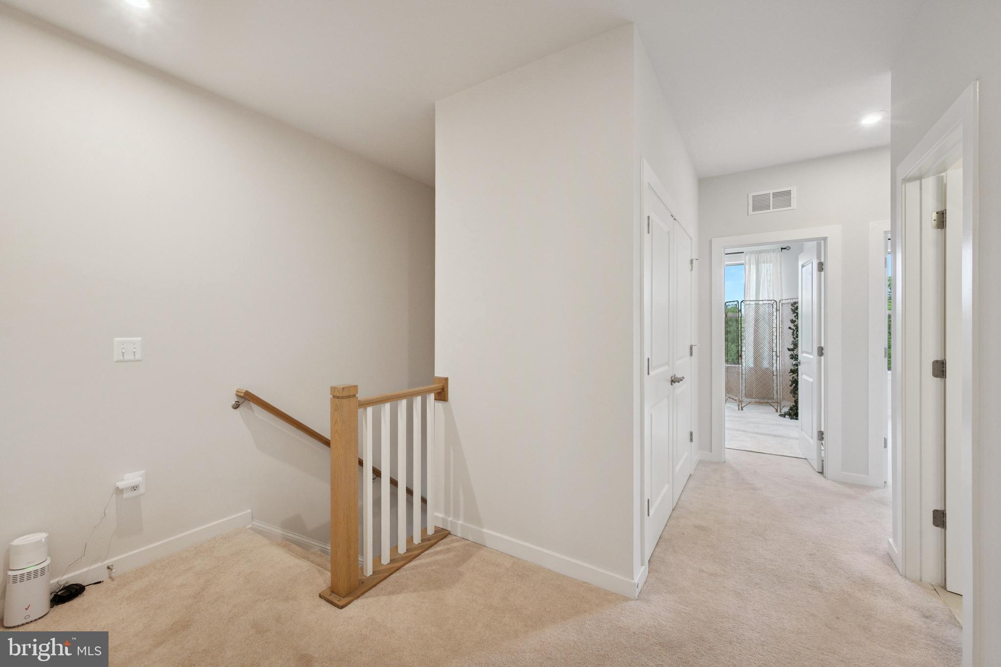 13506 Innovation Station Loop, Unit 2B Herndon, VA 20171 - Photo 24 of 32 a view of a livingroom with a hallway